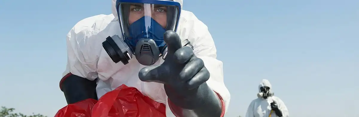 sewage clean up technician wearing protective gear handling biohazard materials in Pittsburgh, PA