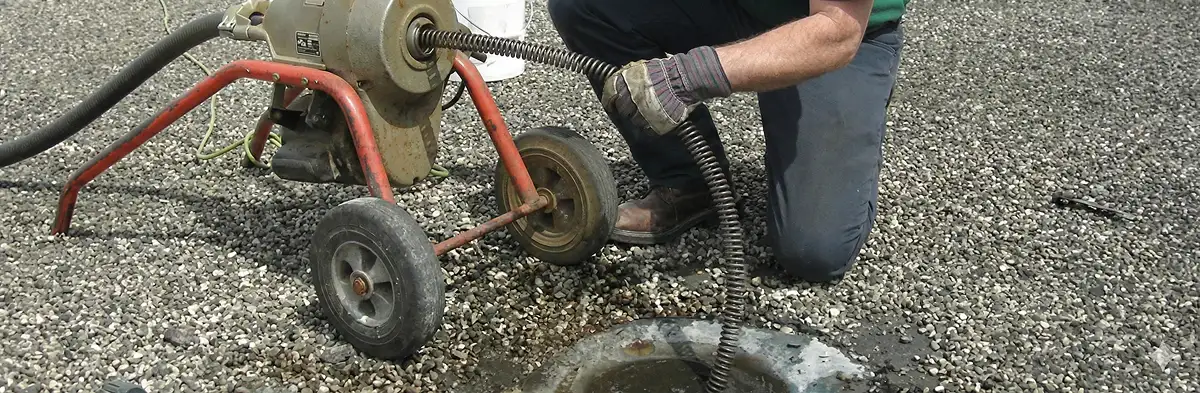 sewer rodding technician actively removing blockages from a sewer line in Pittsburgh, PA